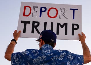 Another sign reads, ‘Deport Trump’